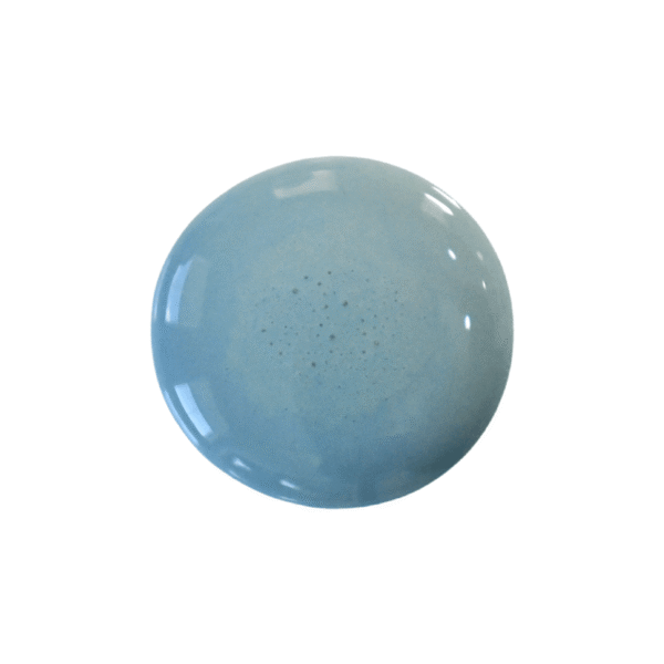 a drop of moody blue milk paint on a white background