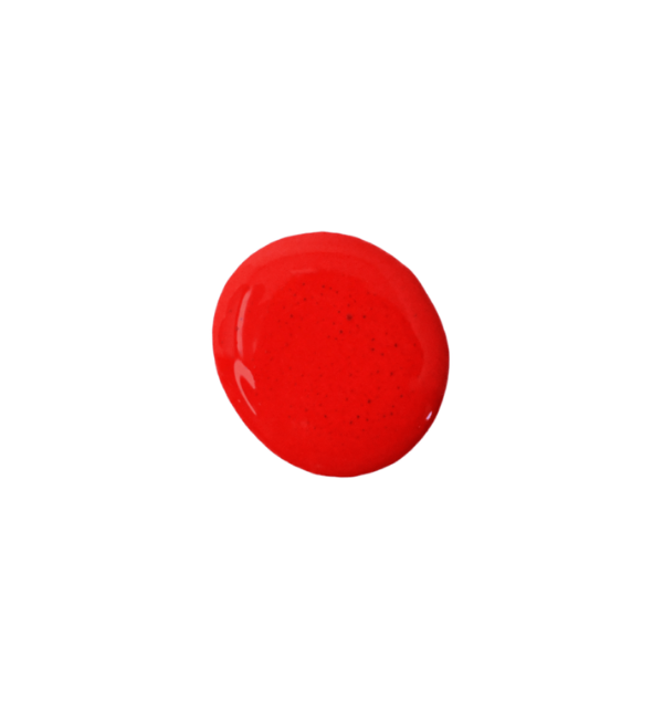 a drop of scarlet milk paint on a white background