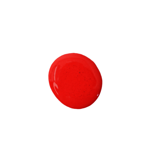 a drop of scarlet milk paint on a white background