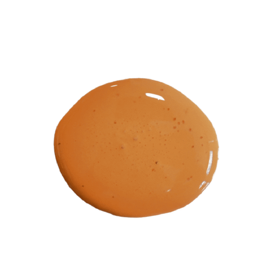 a drop of sweet potato milk paint on a solid white background.