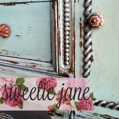 Decorative frame with floral text 'siveetie jane' on a light blue background
