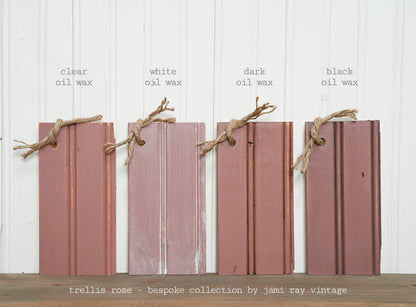 Four wooden planks with different oil wax finishes on a white background