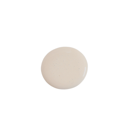 a drop of truffle milk paint on a solid white background.